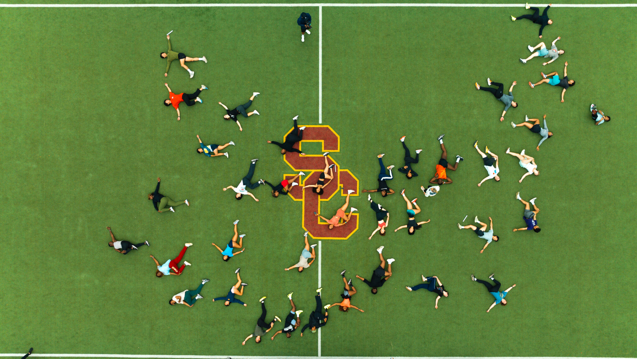 sky view of students stretching on field